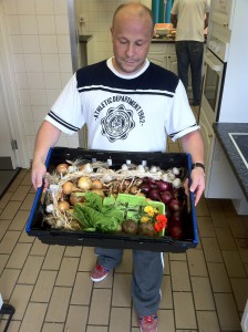 man holding box of vegetables