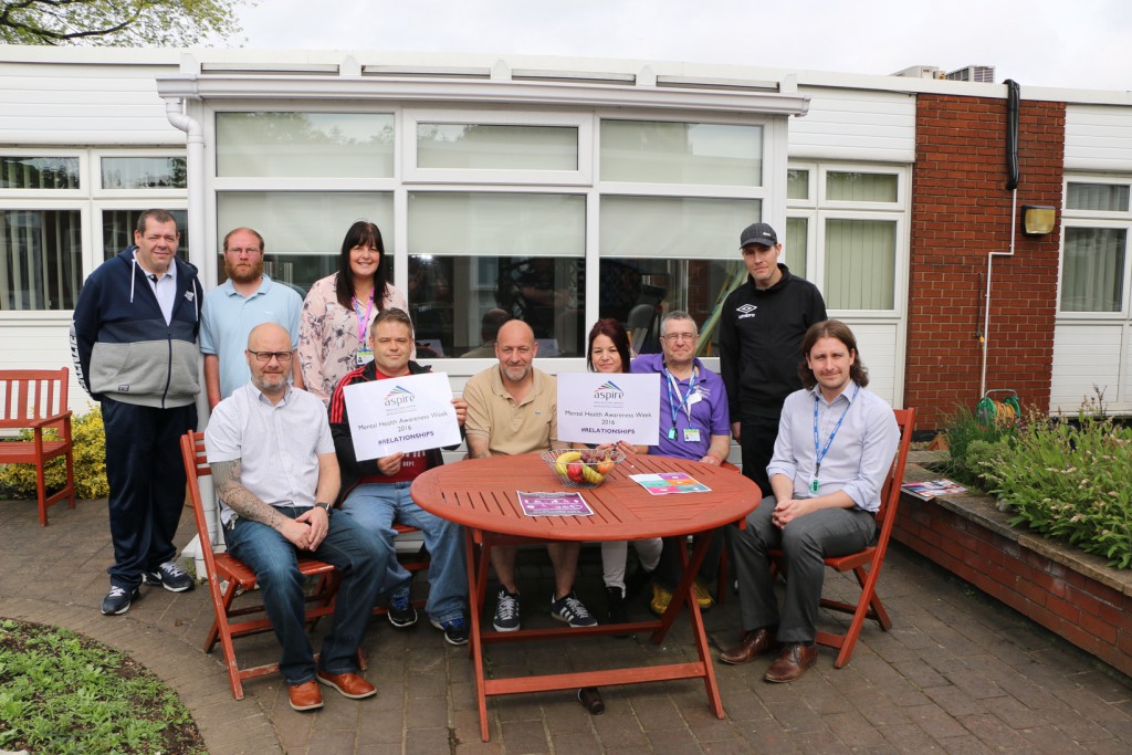 RDaSH Cognitive Behavioural Therapist Dennis Convery (seated right) with Aspire’s Day Programme Manager Paul Wade (seated left) and Team Leader Lesley Chimes (back row third from left) with service users at the Mental Health Awareness Week event at New Beginnings.
