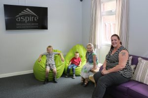 A family sitting in New Beginnings Family Room