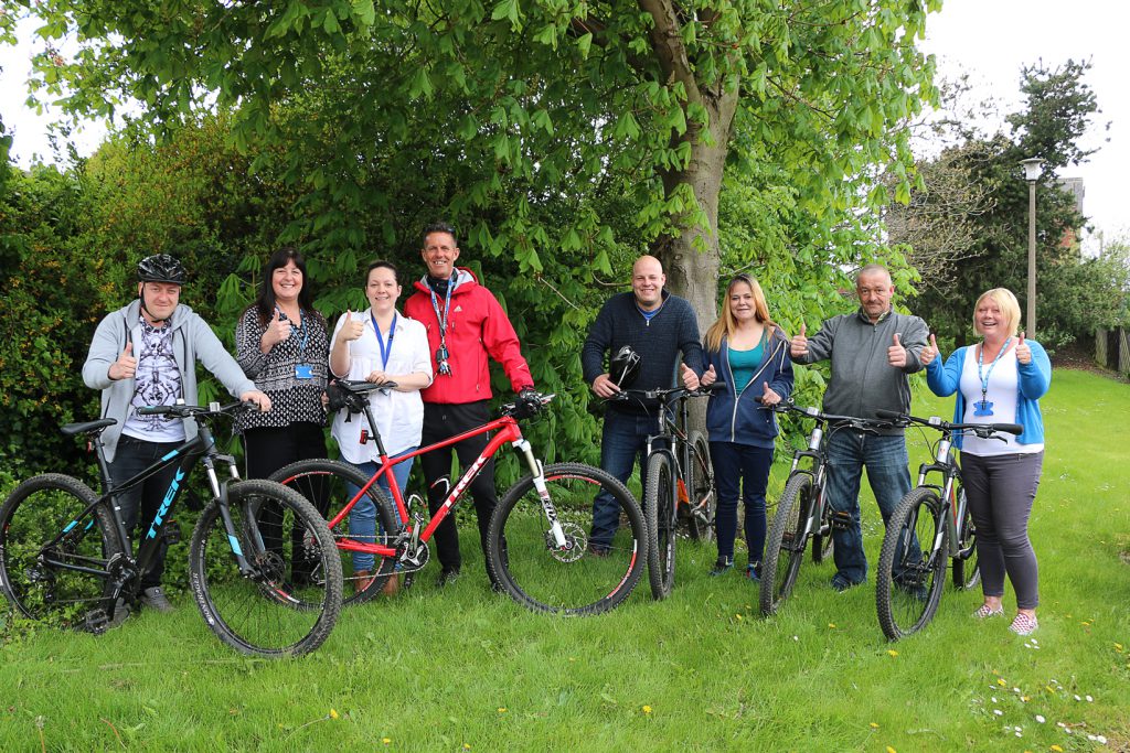 Aspire New Beginnings Team Leader Lesley Chrimes (second from left) and Chris Green of Doncaster Community Leisure Trust (fourth from left) with Aspire staff and service users preparing for a stress busting bike ride around Balby.