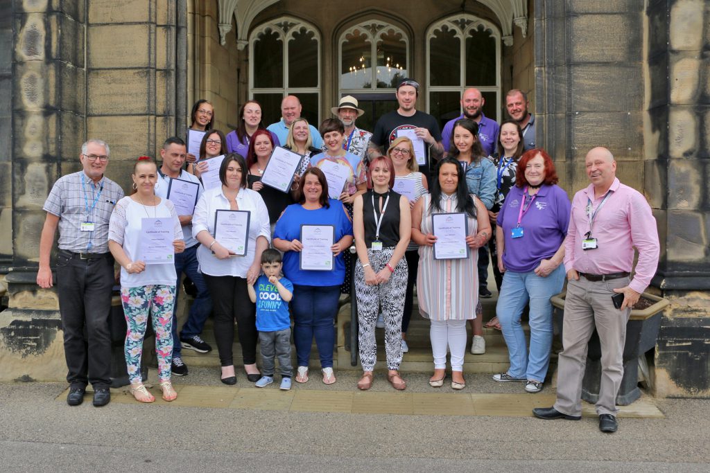 Aspire volunteer peer mentors pictured with staff and family members at the graduation event in Balby. 
