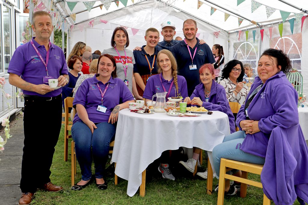 Neil Firbank is pictured fourth right with volunteer mentors and some of the people at the event.